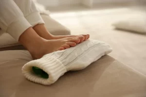 A foot on a hot water bottle - a common cause of chilblains as the toes are warmed quickly.
